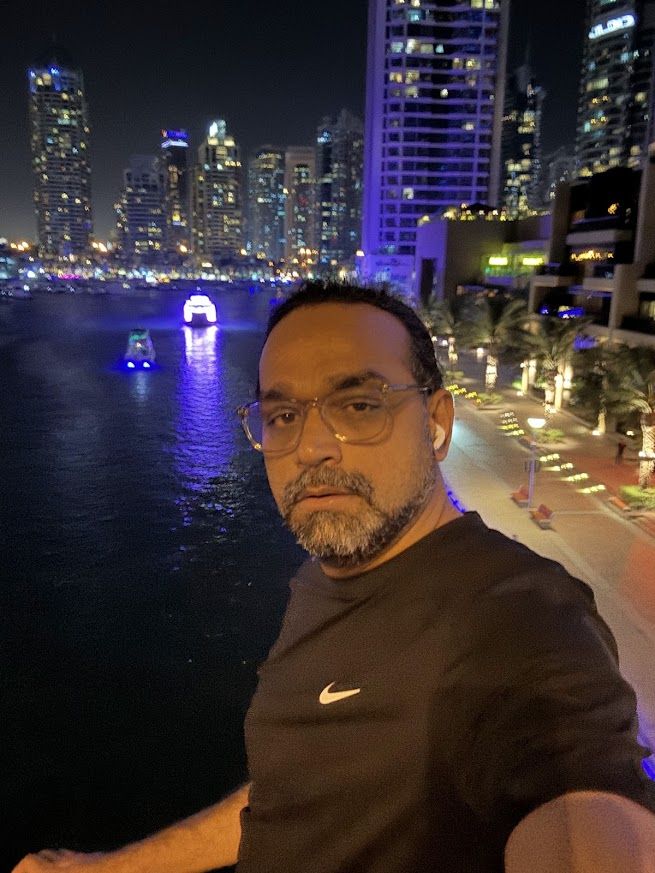 Girish overlooking Dubai Marina at night